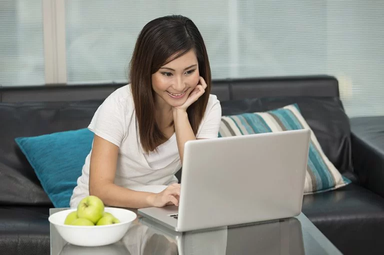 young woman looking at her laptop