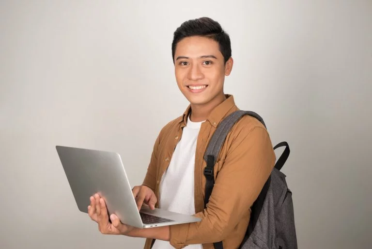 young man holding his laptop