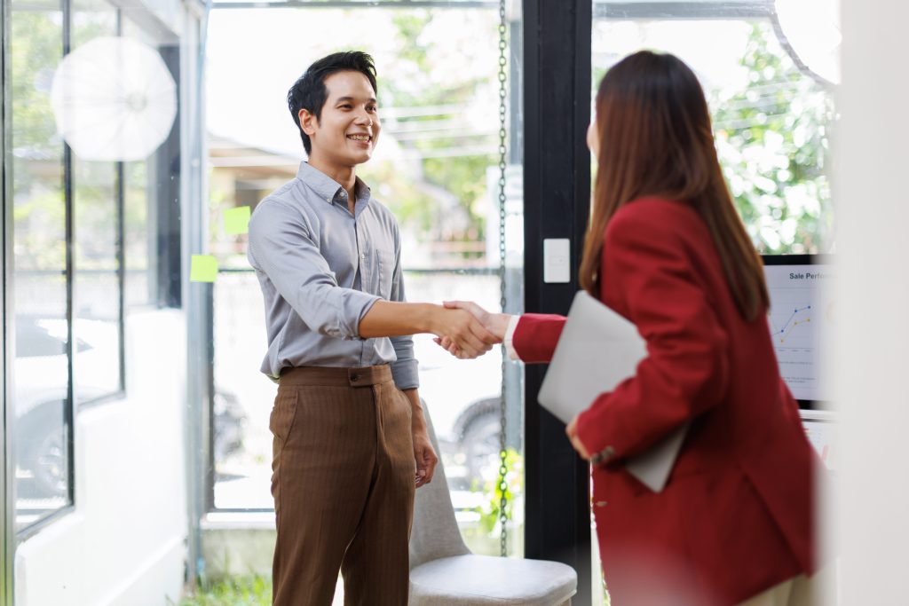 a hiring specialist shaking hands with a candidate