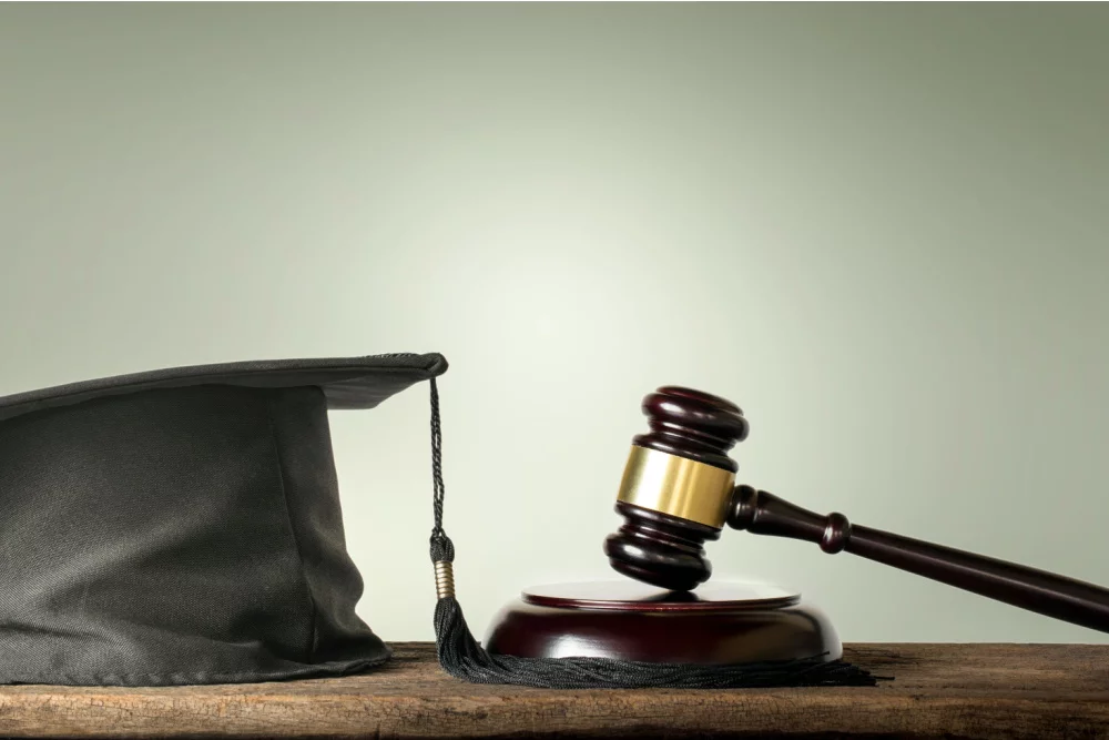 a graduation cap and judge hammer