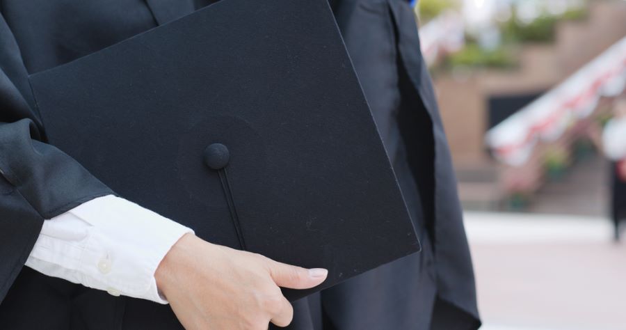 a student holding a graduation cap