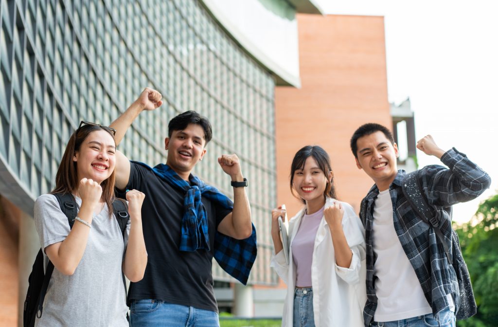 group of friends smiling and cheering