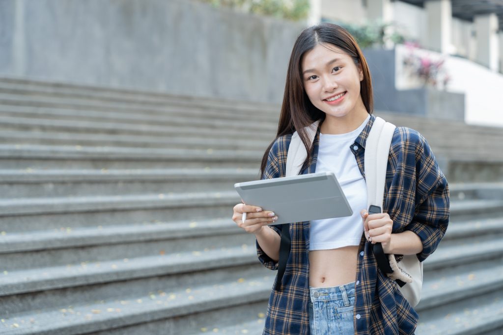 a female student holding a tablet