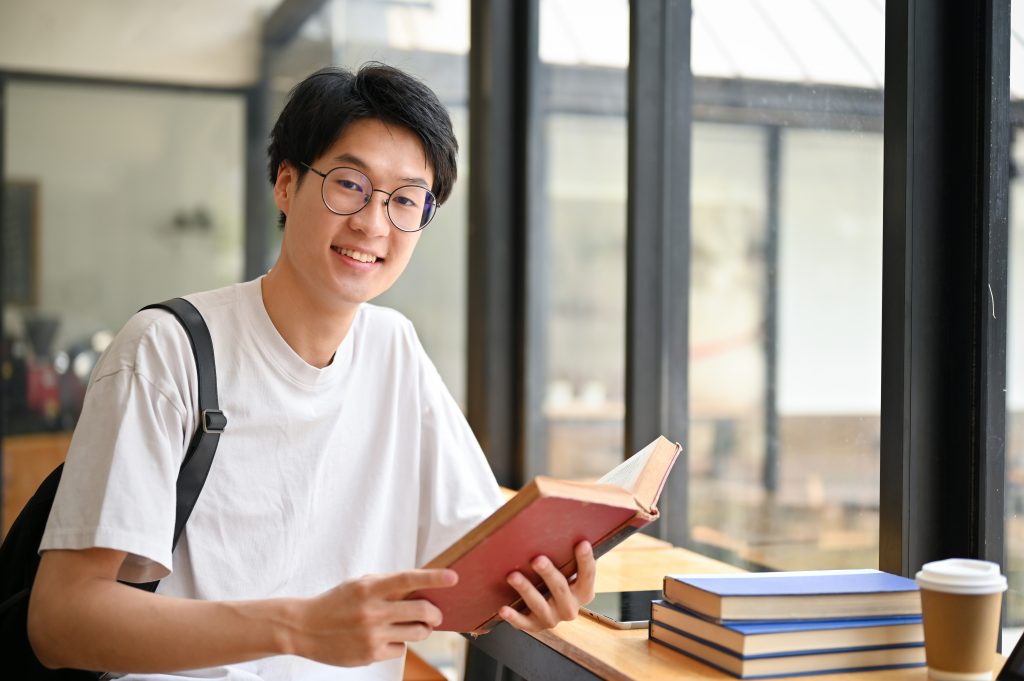 a college student with glasses studying diplomacy