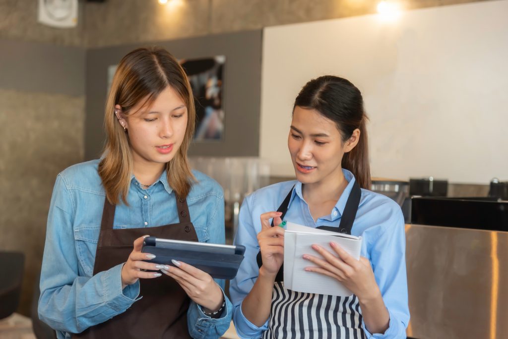 two hospitality students looking at a tablet