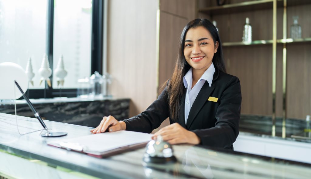 a hotel receptionist smiling