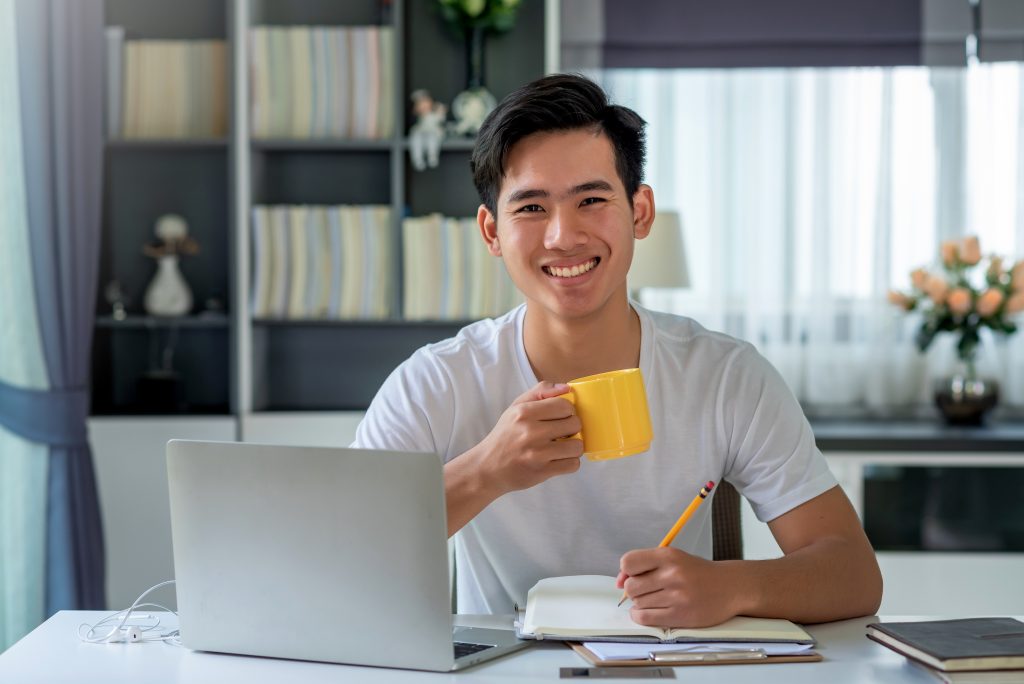 a data science student holding a cup