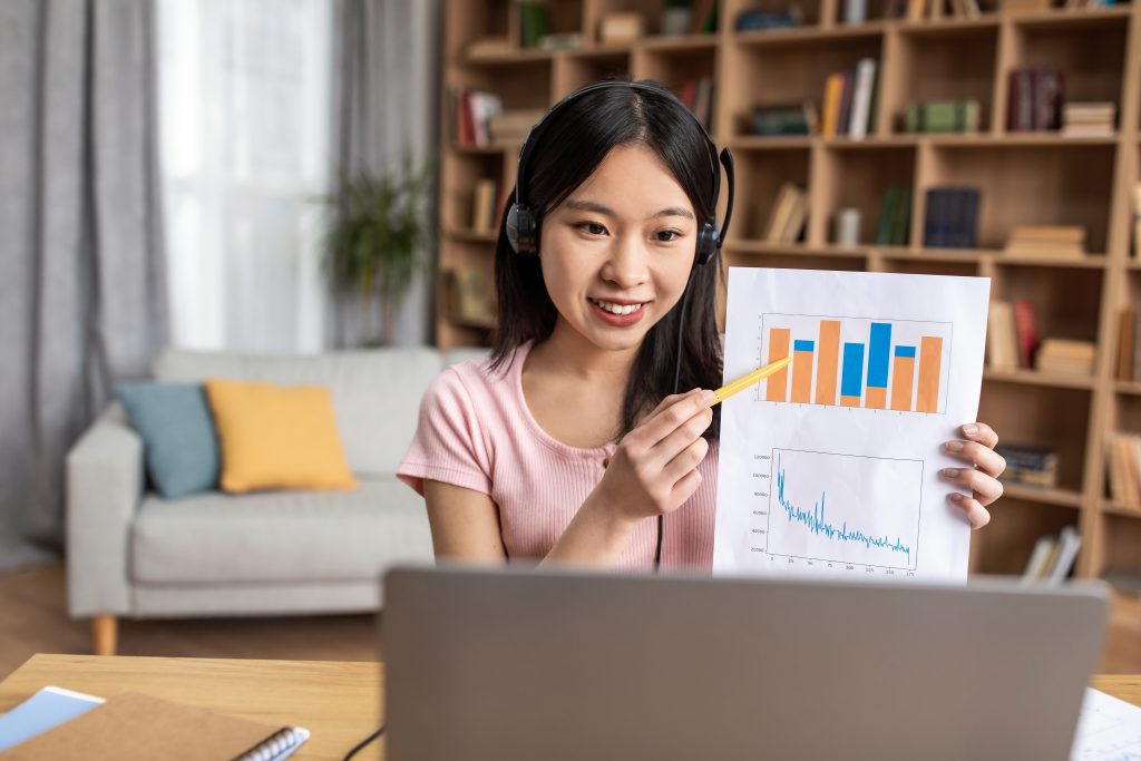 a data science student pointing at the graphs