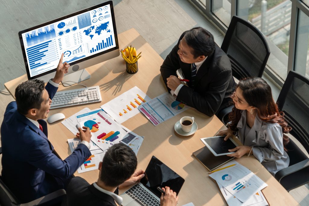 a group of data analysts looking at a screen