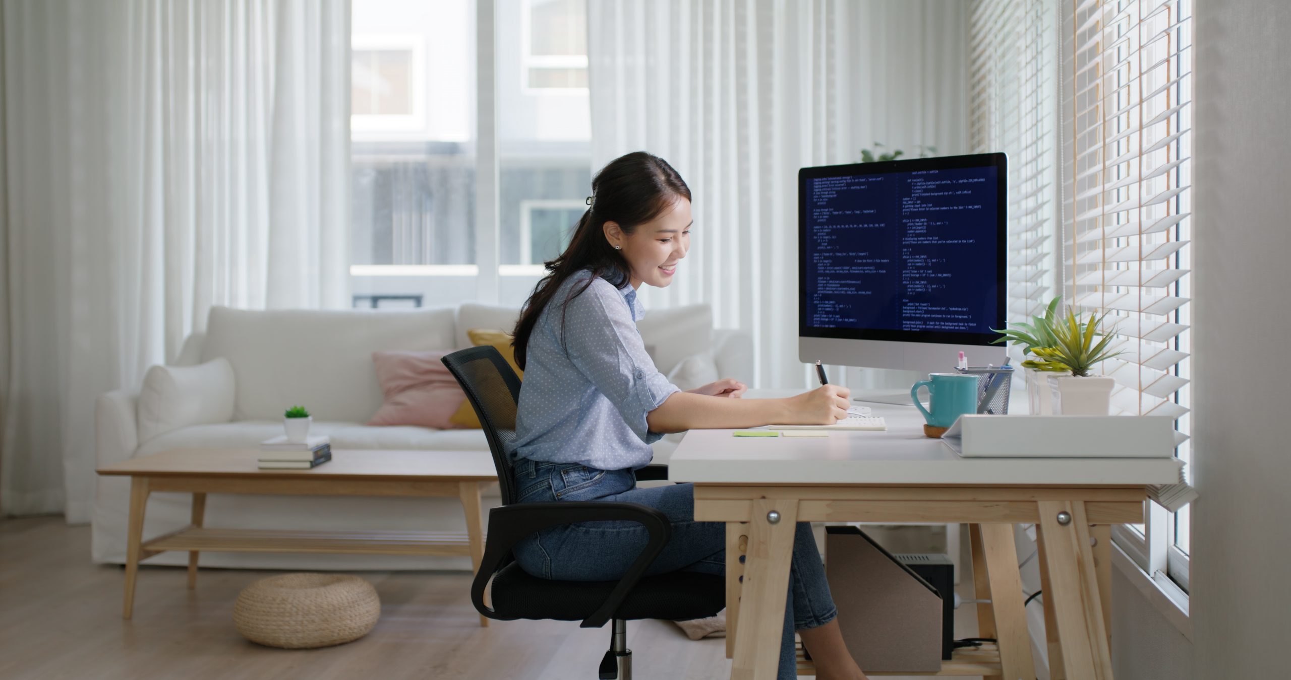 a data analyst writing on her notebook