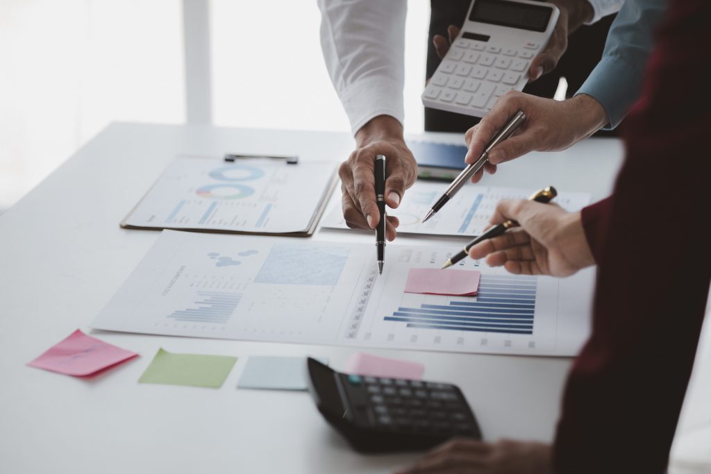 a group of accountants pointing at a graph