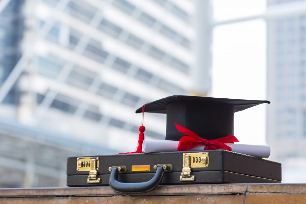 graduation hat on a hard suitcase