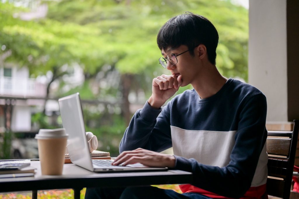 a male college student attending an online class